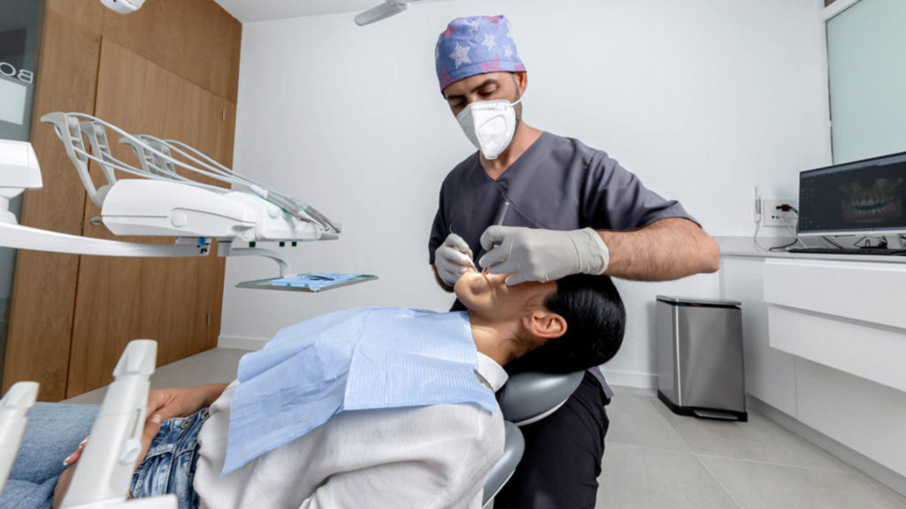 Photo of an emergency dentist working on a patient.
